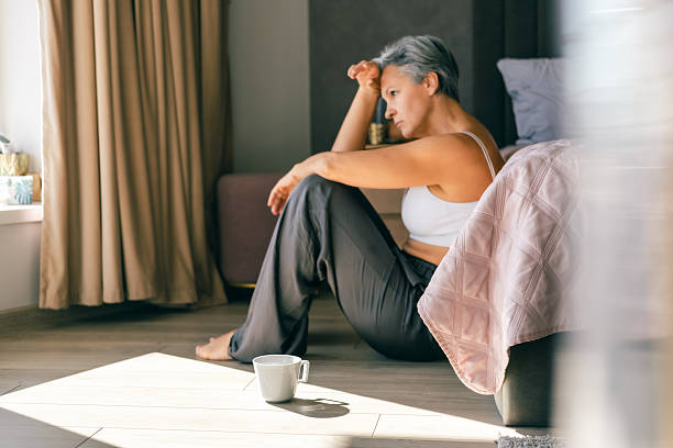 Person sitting quietly by a window with morning light